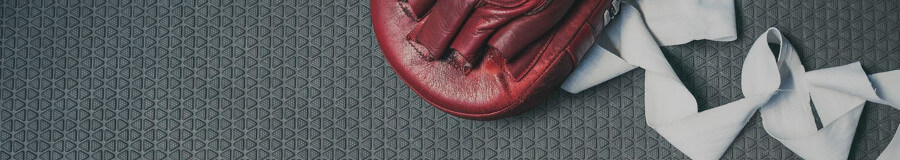 Boxing Glove and Bandages on Gym Floor