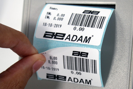 Person Peeling Off Printed Labels on BKT Scale